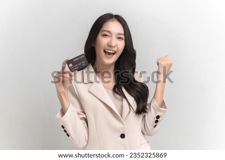 Portrait photo of young beautiful Asian woman feeling happy or surprise shock and looking at camera, holding credit card on white background can use for advertising or product presenting concept.