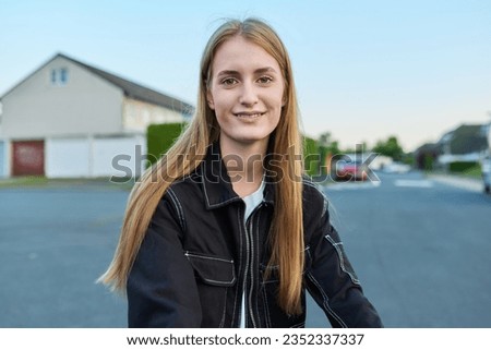 Close-up face of teenage girl, riding outdoor bike