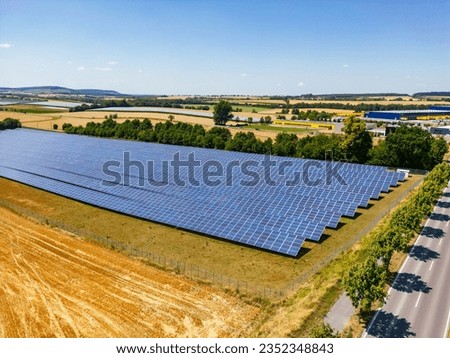 Solar farm with numerous rows of solar panels in a rural area in the south of Germany