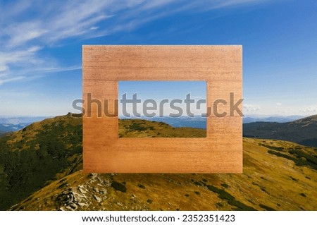 Wooden frame and beautiful mountains under blue sky with clouds