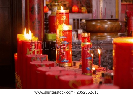 Candles for worship lit in a monastery in Jakarta's Chinatown area. translations: six ways sentient beings