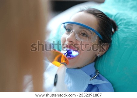 Patient visiting dentist for regular check-up and filling teeth closeup Royalty-Free Stock Photo #2352391807