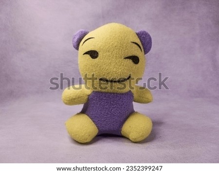 The yellow teddy bear is grinning