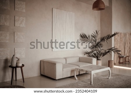 Soft native hues organic shapes look of living room to wood accents in neutrals tones. Green palm plants beige walls and niches different sizes minimalist open space luxury interior ethnic design Royalty-Free Stock Photo #2352404109