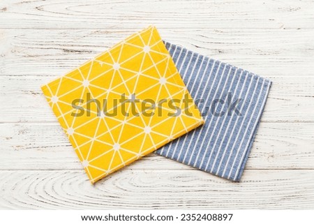top view with yellow empty kitchen napkin isolated on table background. Folded cloth for mockup with copy space, Flat lay. Minimal style. Royalty-Free Stock Photo #2352408897