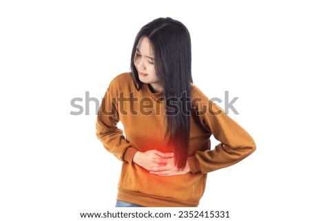Sick Asian woman having a stomach ache isolated on white background with clipping path.