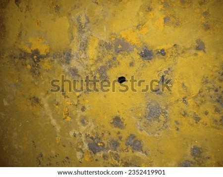 rust process on a yellow plate with a perforated texture
