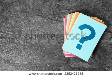 Question mark sign and symbol on colorful paper notes stack business and customer faqs concept on grey background with copy space.