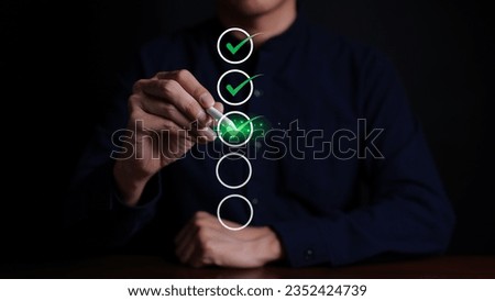 Businessman checking mark on checklist with a red checkmark. online checklist survey, filling out digital form checklist. take an assessment, questionnaire, evaluation, online survey, online exam. Royalty-Free Stock Photo #2352424739