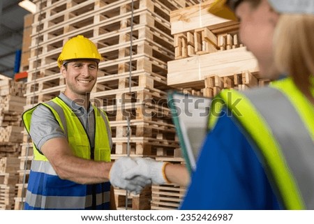 Technician shaking hand after checking and inspecting at cargo for stack item for shipping. males worker checking the store factory. industry factory warehouse.