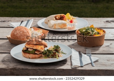 A meal set for a hearty lunch for two at an Italian café - burgers, appetizer, French fries, food photo