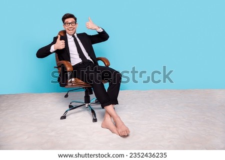 Full length photo of funky funny man wear black suit showing two thumbs up distance working empty space isolated blue color background
