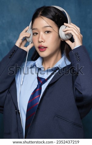 Beautiful Asian woman in school uniform taking a photo of yearbook trend. American yearbook trend popular portrait photography style in Asia.