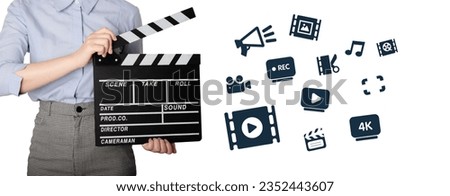Woman holding Clapperboard or movie slate use in video production ,film, cinema industry. The hand is holding clapper board or movie slate. Hands Holding a Film Slate Directing a Movie Scene.  Royalty-Free Stock Photo #2352443607