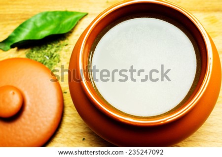 Broth, bouillon, clear soup in a clay pot, close-up