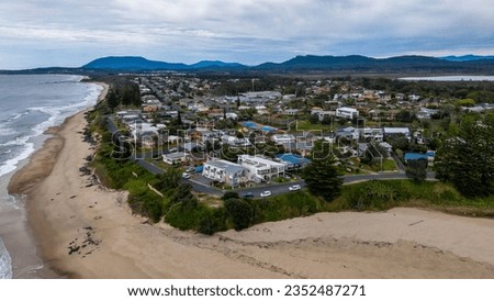 An aerial shot of the Lake Cathie with buildings nearby in New South West, Australia
