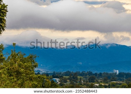 Beautiful mountain landscape and city panorama with forest trees clouds and nature of San José and Heredia in Costa Rica.