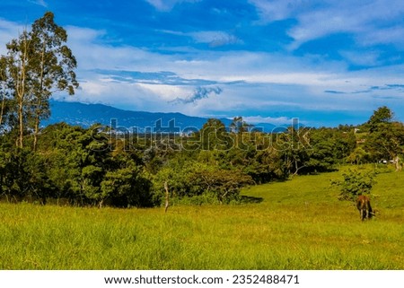 Beautiful mountain landscape and city panorama with forest trees clouds and nature of San José and Heredia Costa Rica in Central America.