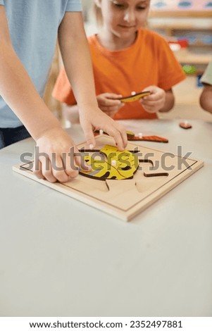 interracial kids playing with didactic montessori material in school, learn and play, boys and girl Royalty-Free Stock Photo #2352497881