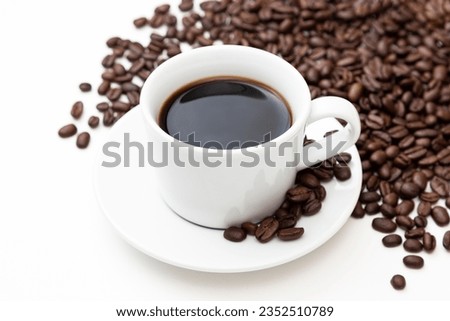 Coffee beans and hot coffee on white background.