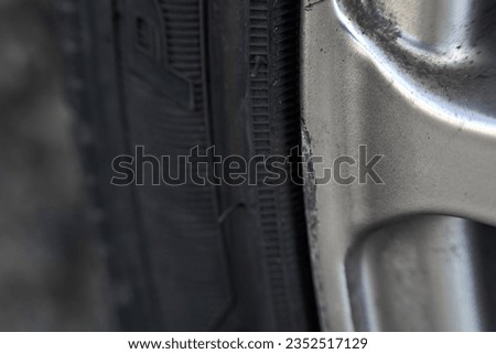 Curbed silver alloy wheel. Refined Alloy Wheels. Repairing Chipped Abrasions for Enhanced Aesthetics Royalty-Free Stock Photo #2352517129