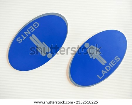 blue board labels for men's and women's restrooms on white background