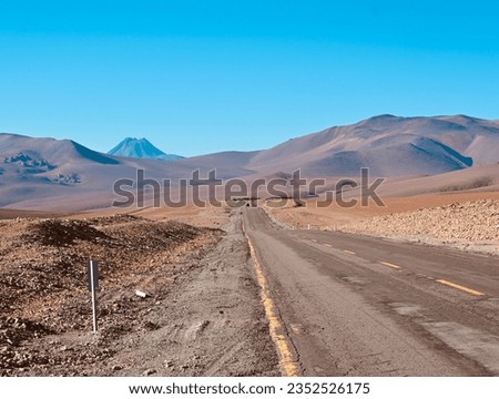 The Atacama Desert with a road under the clear blue sky Royalty-Free Stock Photo #2352526175