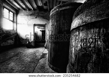 A very old barrels inside an abandoned countryhouse. Royalty-Free Stock Photo #235254682