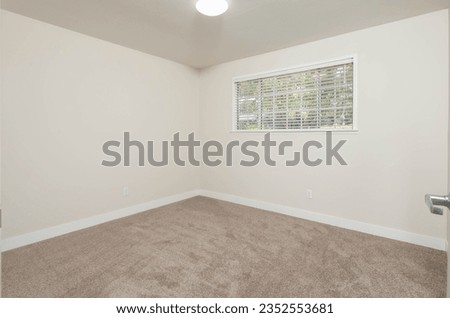 a empty bedroom with carpet and a window and bright walls, great for virtual staging interior design