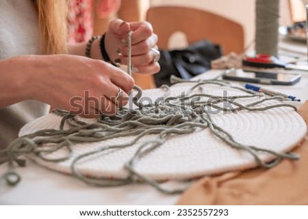 Woman's hands weave macrame decor. Handicrafts advertisement. Copy space