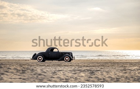 Very nice old black classic car, three-window coupe. Year of construction 1936. On the beach in Rømø Denmark. Royalty-Free Stock Photo #2352578593