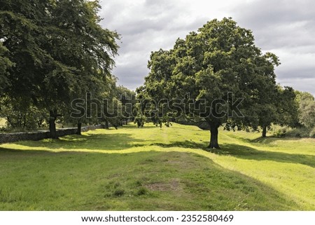 Summer time on the John Muir Way long distance walking trail at the site of the Antonine wall and Roman fort at Rough Castle, Bonnybridge, Central Scotland. Royalty-Free Stock Photo #2352580469