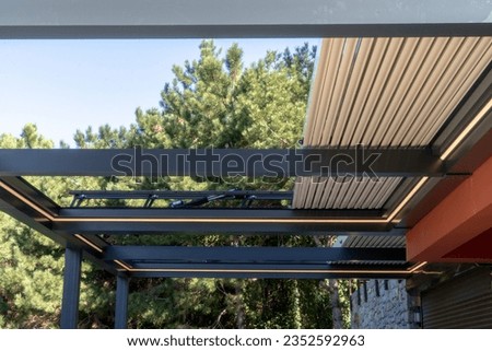 Pergola awning in the sunshine photo Royalty-Free Stock Photo #2352592963