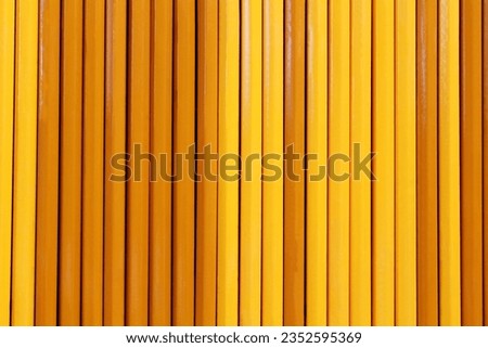Row of yellow color wooden pencils isolated as wood texture background, Back to school and art,graphic,education concept