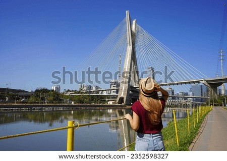 Visiting Sao Paulo, Brazil. Rear view of traveler woman looking at Ponte Estaiada bridge in Sao Paulo, Brazil. Royalty-Free Stock Photo #2352598327