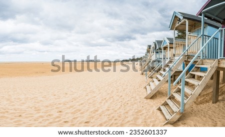 A multi image HDR panorama of the steps leading up to the dozens of beach huts on the coastline at Wells next the Sea on the North Norfolk coast. Royalty-Free Stock Photo #2352601337