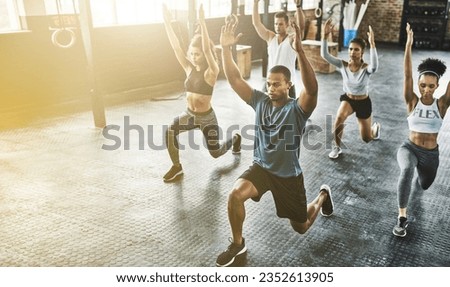 Lunge, group or people in gym with personal trainer for balance, fitness training or a healthy body. Women, men or coach instructor in exercise or workout for strong legs in wellness studio class Royalty-Free Stock Photo #2352613905