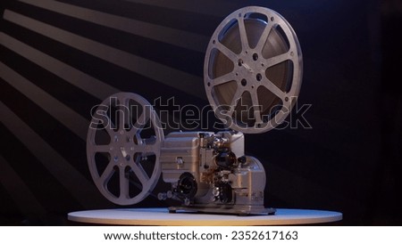 Old vintage movie projector for playing film. 16mm retro projector general view rotates. concept of an old film or cinema.