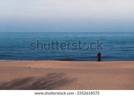 The beach of the Caspian Sea and a single Muslim woman. High quality photo