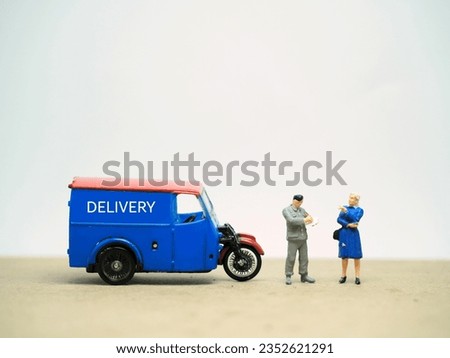 Mini toy at table with blurred background. Delivery service concept design.