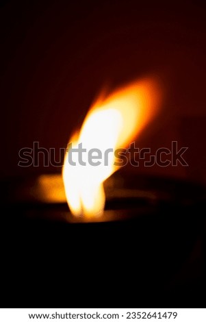 A beautiful abstract shape made of fire flame in the darkness. Abstract fire flamed textured background.