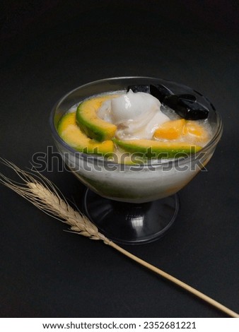 Es teler, a mocktail consisting of avocado, mango chunks, black grass jelly, young coconut with coconut milk and milk