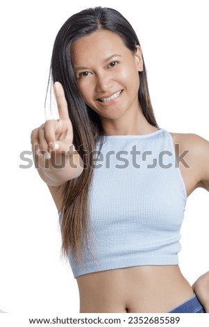 Beautiful Asian Woman using her finger to count one isolated on a white background with copy space