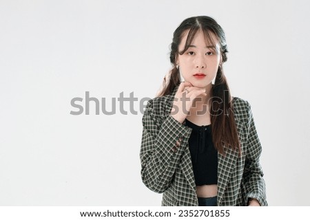 Portrait isolated cutout studio shot of Asian young cute female fashion model with pigtails braids hairstyle in casual plaid suit and crop top shirt standing posing look at camera on white background.