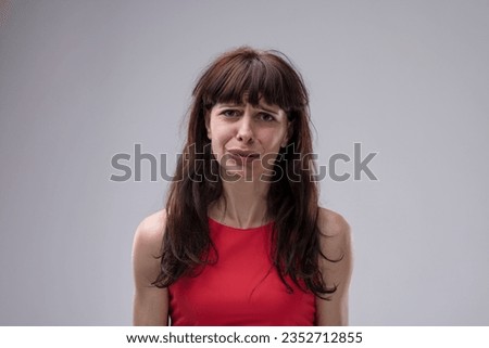 woman's face reveals strong disdain turning into fear. Disturbed by upsetting news, she's in dire need of help to resolve a horrifying situation Royalty-Free Stock Photo #2352712855