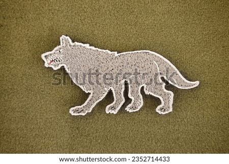 The emblem of the snow wolf patch is velcro, used for attaching clothes and bags.