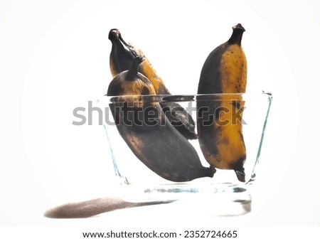Isolated picture of rotten bananas in a glass