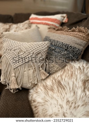 Cozy sofa corner with trendy textured boho toss pillows Royalty-Free Stock Photo #2352729021