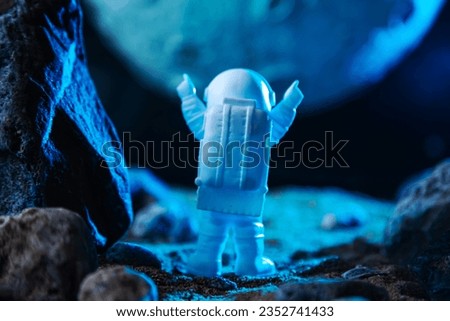 Astronaut in a space suit raised his hands in a sign of welcome on another planet. Space background, concept of the future.