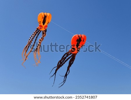 Two Octopus Kites against blue sky  